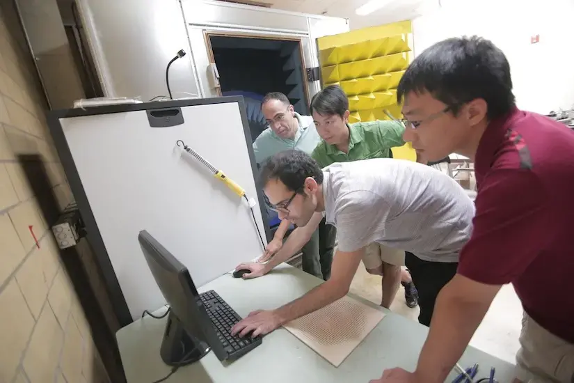 Amin Momeni (standing at computer), who recently completed his PhD in Behdad’s group, investigates the three-dimensional radio signal being emanated from a prototype antenna. The device is able to send scanning beams in multiple directions from a stationary position. Nader Bedahd (standing, left), Seyed Mohamad, and Hasan Abadi observe.