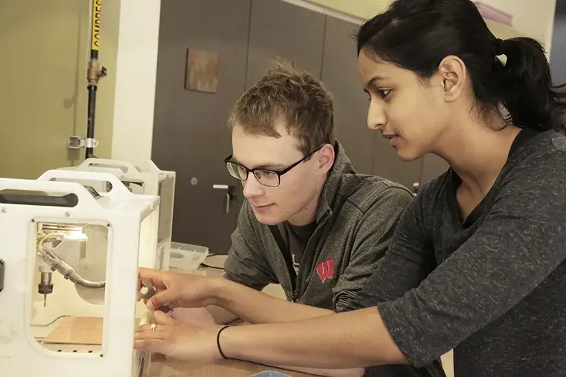 two students working in the college makerspace