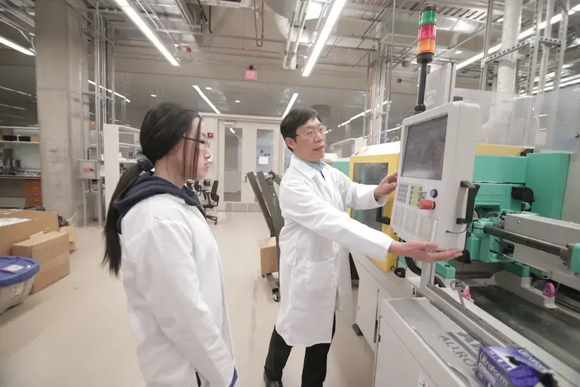 Tom Turng using a micro-injection molding machine