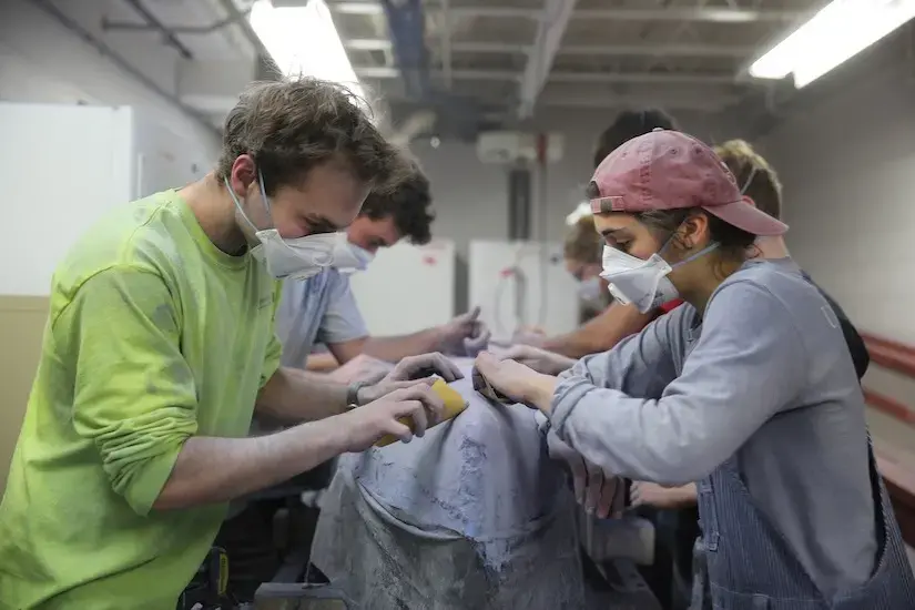 students working on concrete canoe