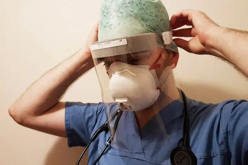 person wearing a face shield and mask