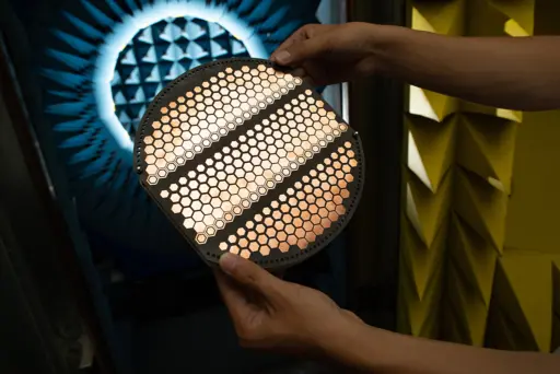 person from ECE Laboratories August 2022 holding computer wafer