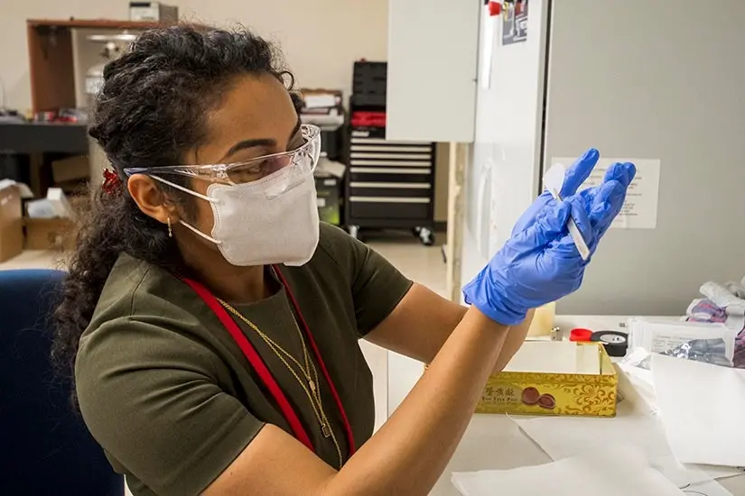 Shubhra Pasayat viewing sample in lab
