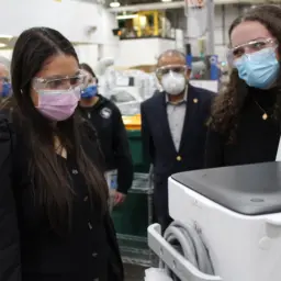 Students examine an anesthesia delivery unit at GE Healthcare