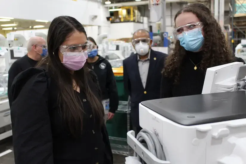 Students examine an anesthesia delivery unit at GE Healthcare