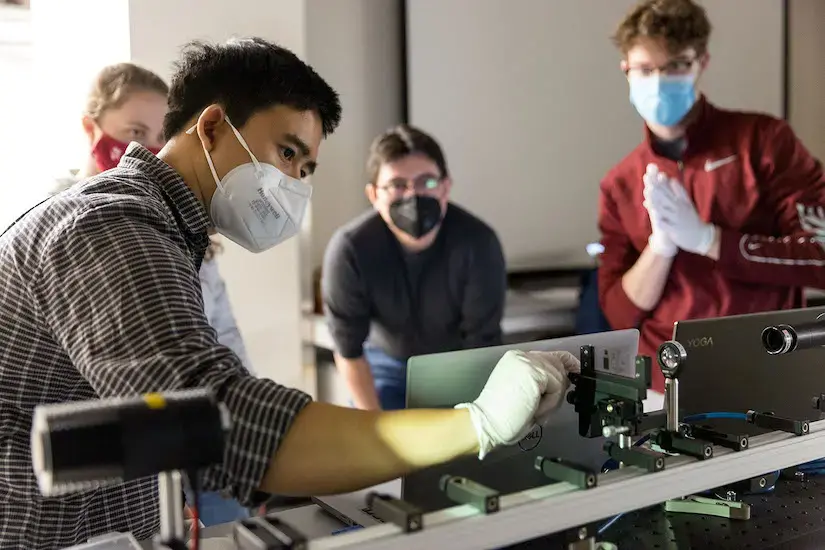 Students working with a microscope system in lab course