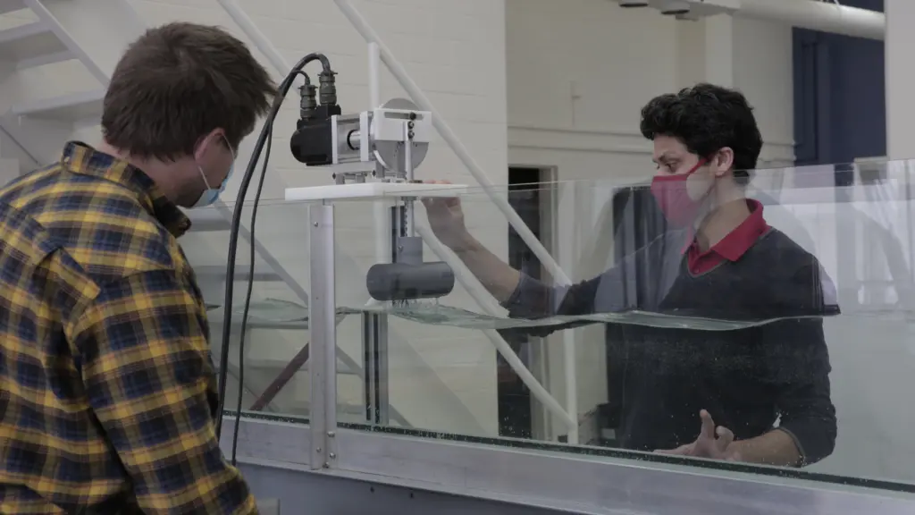 Nimish Pujara works with faculty associate Jacob Zeuske to test a wavemaker