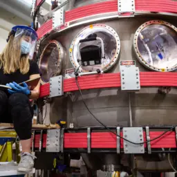 Carolyn Schaefer, a PhD student in engineering physics, works on the Pegasus-III fusion experiment