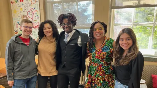 Four students pose and smile with Dr. Ebony McGee in the IEDE Student Center