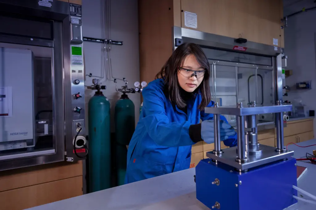 Fang Liu assistant professor in materials science and engineering at the University of Wisconsin-Madison working in lab