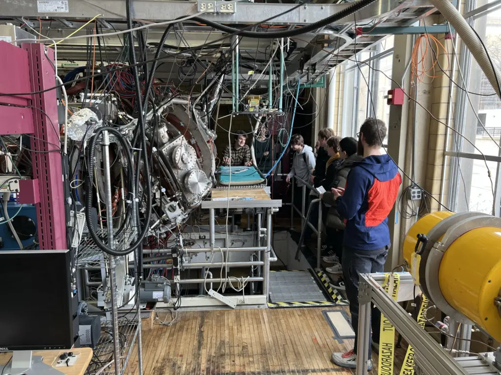 Alex Thornton talks to students in front of stellarator