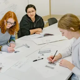 Students Kate Nelson and Madison Noe practice drawing techniques with Kate Fu