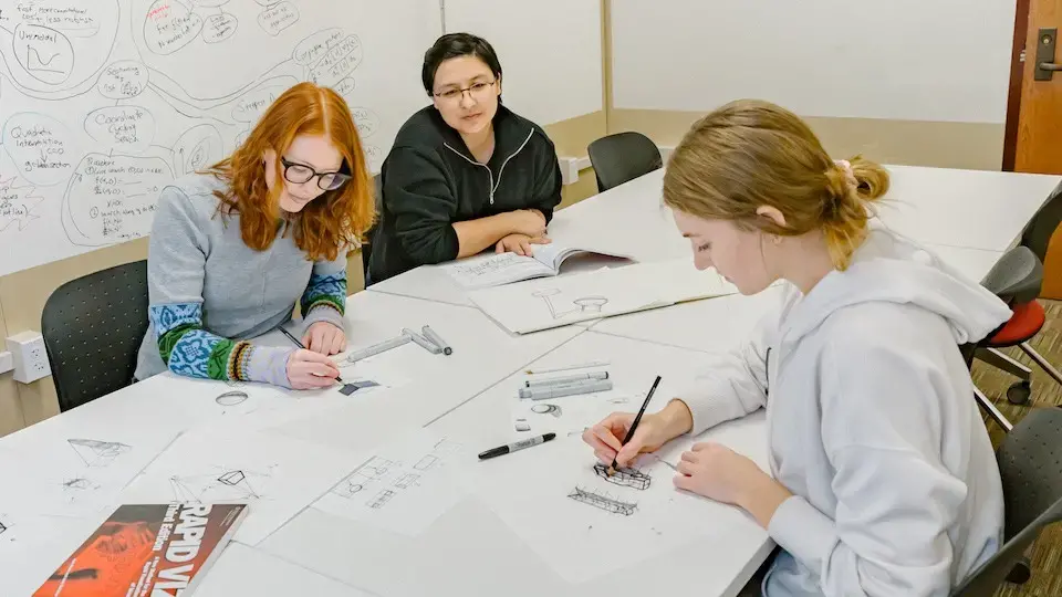 Students Kate Nelson and Madison Noe practice drawing techniques with Kate Fu