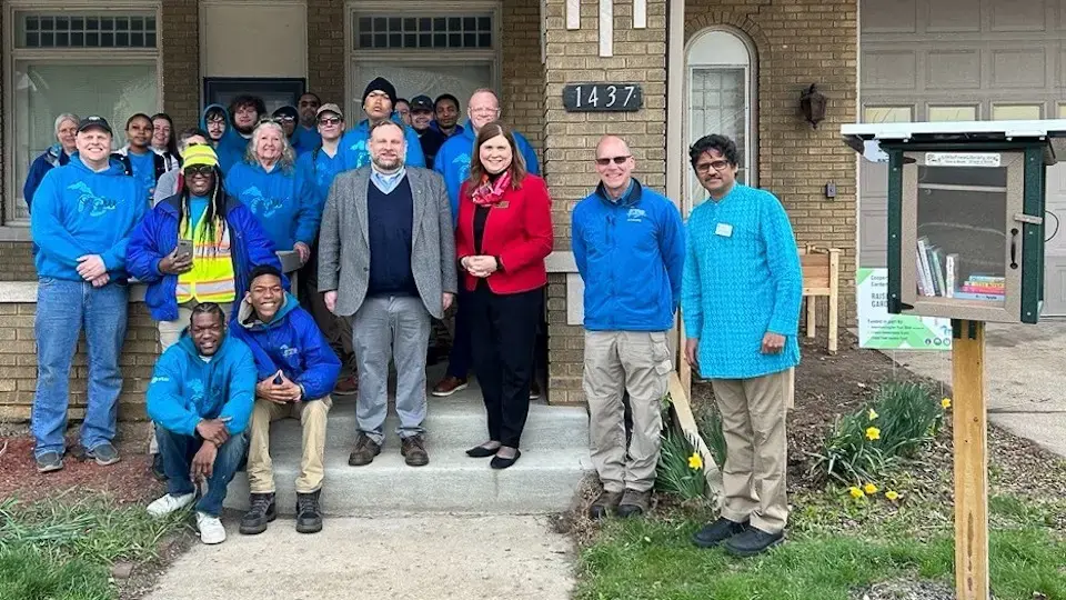 Kathy Blumenfeld, Giri Venkataramanan and others gathered by the solar Little Free Library project