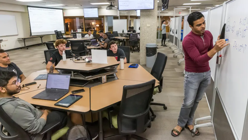 Bhumesh Kumar, right, a PhD student in electrical and computer engineering, guides students through a problem during a session of ECE 532: Matrix Methods in Machine Learning.