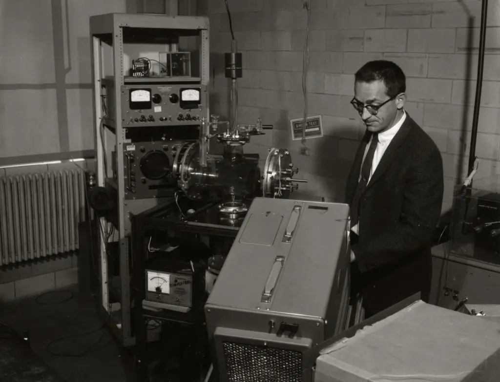 Electrical engineering professor James Beyer in a room of equipment