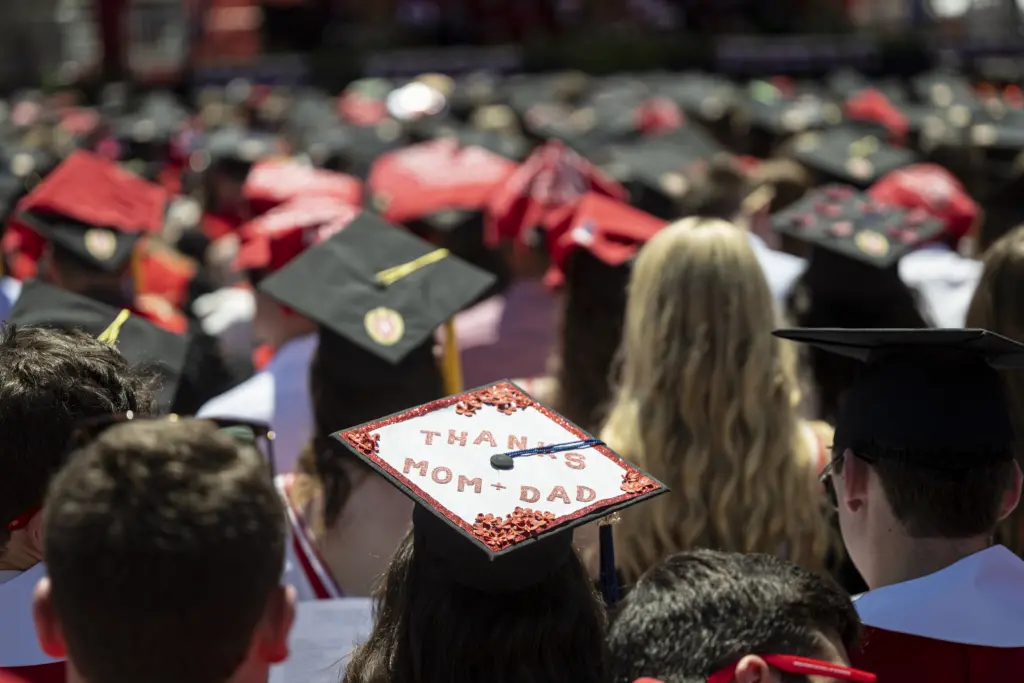 A UW graduate displays a personal message on the top of their graduation cap during UW–Madison's spring commencement ceremony at Camp Randall Stadium at the University of Wisconsin-Madison on May 14, 2022.