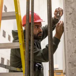 A CEE student checks a concrete specimen for cracks