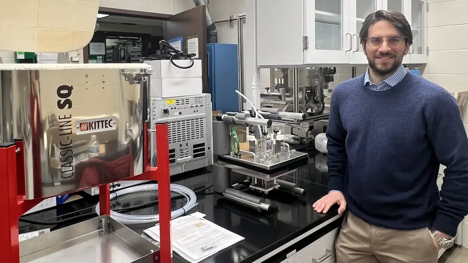 Luca Mastropasqua in his lab with a high-temperature electrolysis testing station.