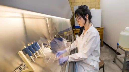 PhD student Yizhou Yao working in the lab