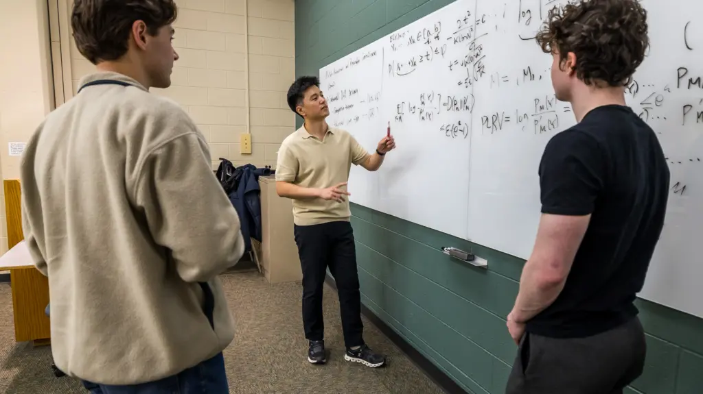 Kangwook Lee talking with students