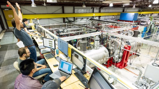 Researchers celebrate achieving a plasma from the control room at the Wisconsin HTS Axisymmetric Mirror Project (WHAM) experiment