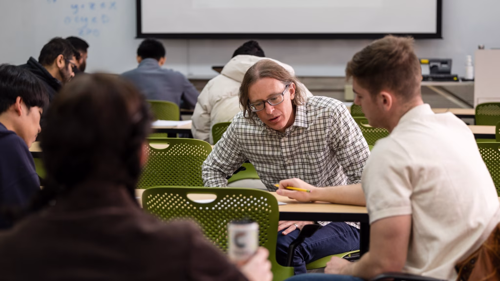 Professor Jim Luedtke works with students in Advanced Optimization Modeling