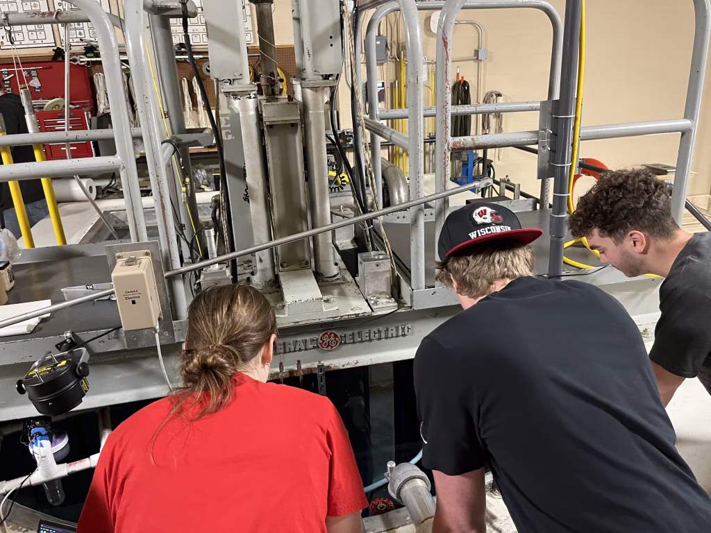 Students peer into the University of Wisconsin Nuclear Reactor pool to see the blue glow