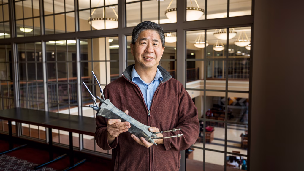 Professor Xiaoping Qian holds the 3D-printed optimized heat exchanger