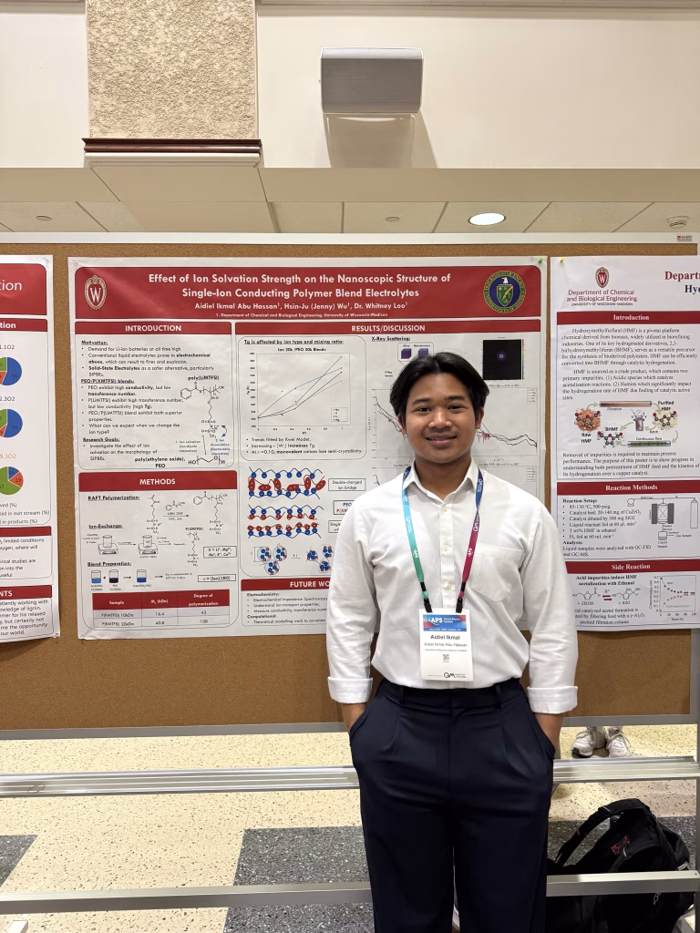 Aidiel Hassan next to poster presentation.