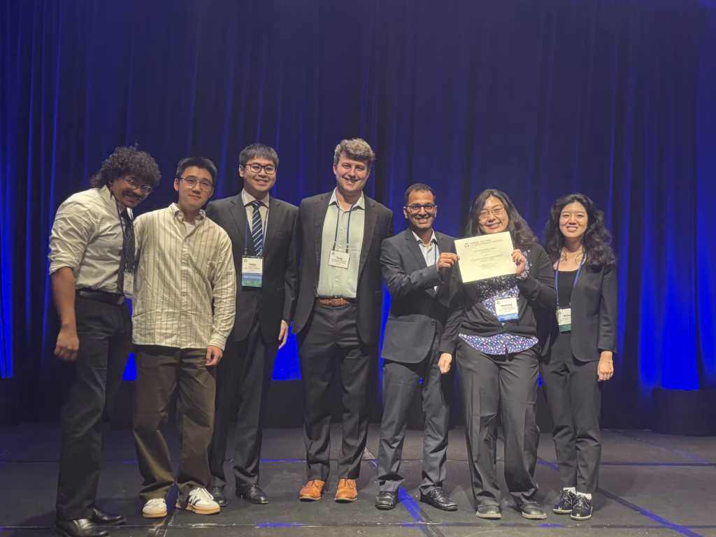A group of students and a faculty advisor holding a certificate