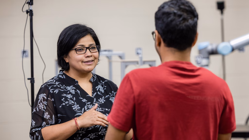 Professor Ranjana Mehta talks with a student in her lab during an experiment.