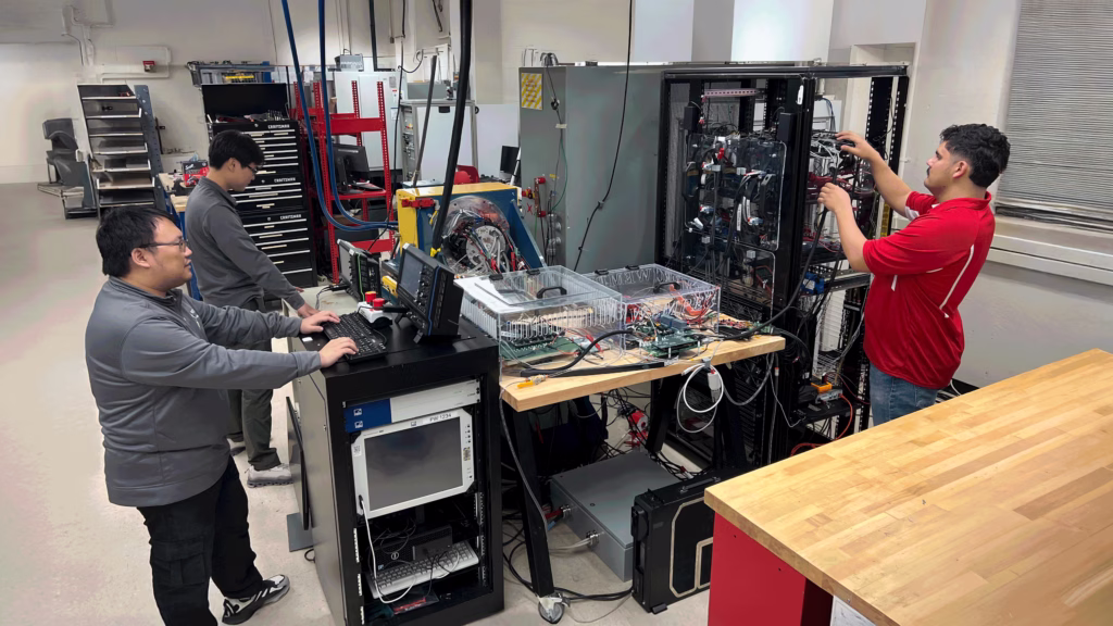 WEMPEC graduate students Xiaoyuan Zhang, Antonio Trujillo Parra and Ken Chen analyze the fault-tolerant motor drive they helped build as part of a NASA supported project.