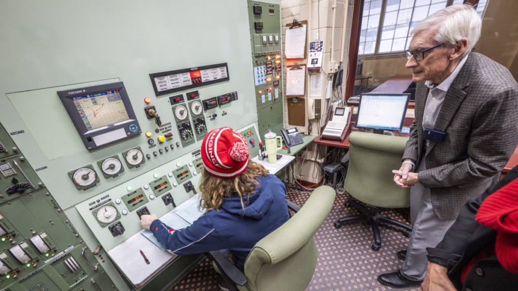 Governor Tony Evers looks at readings in the control room of the University of Wisconsin Nuclear Reactor